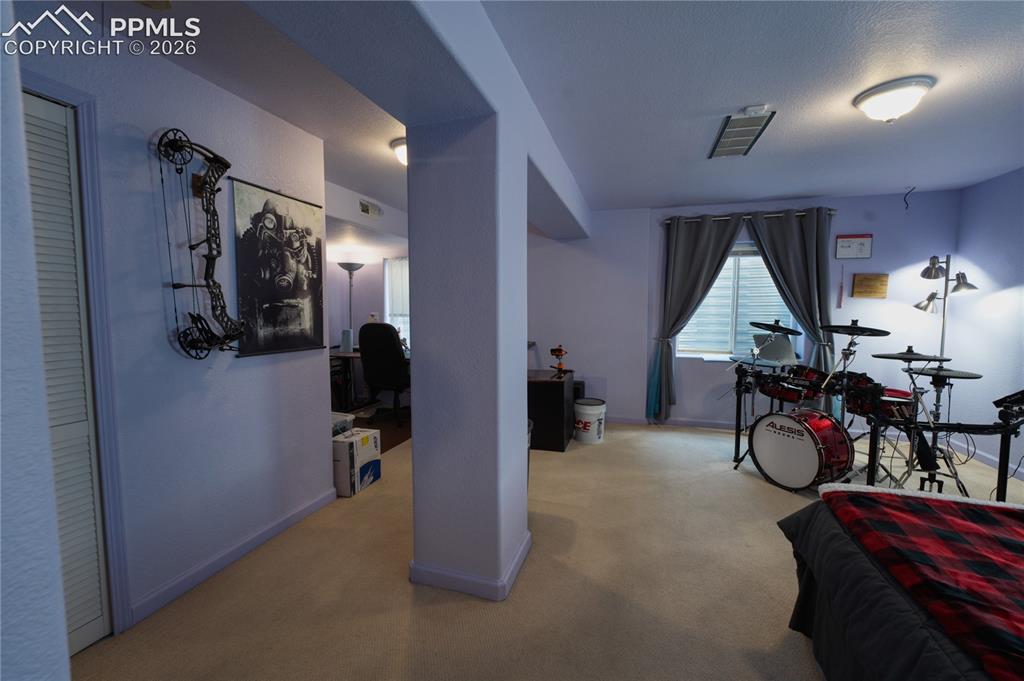 Image 32 of 45: Versatile room featuring carpet flooring, a window with curtains, and flush