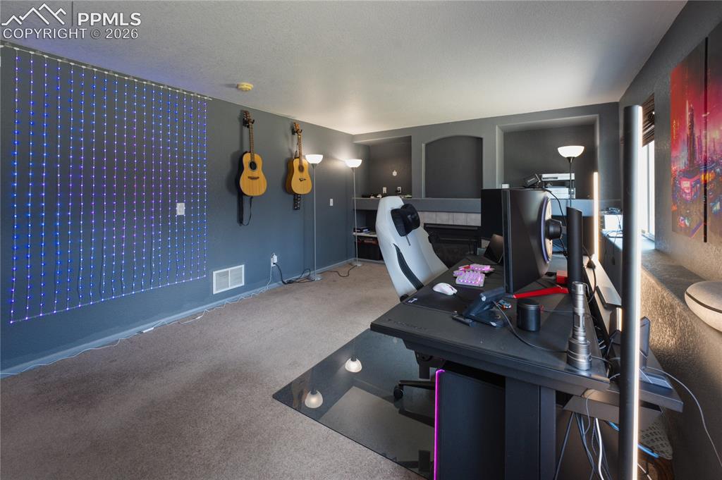 Image 37 of 45: Carpeted room with recessed wall niches and a window