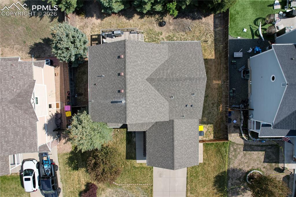 Image 43 of 45: Gable roofline home featuring a gray shingle roof, a concrete driveway, and