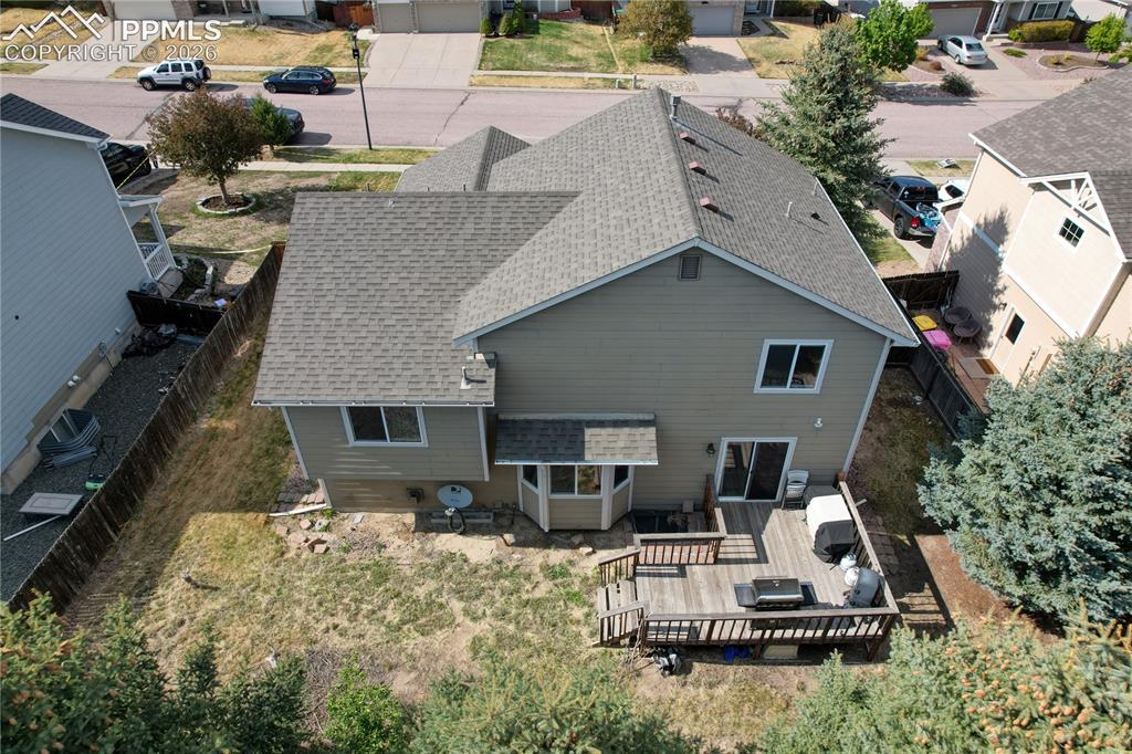 Image 45 of 45: Rear exterior featuring a multi-level wood deck, sliding glass door access,