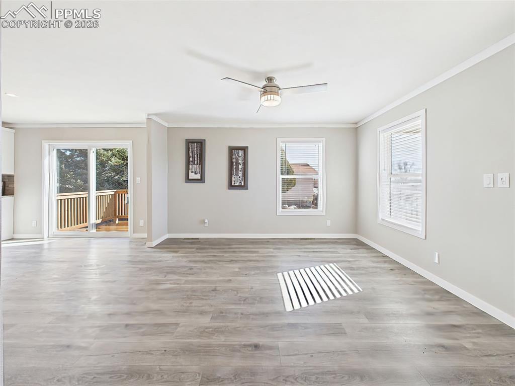Image 10 of 50: Unstaged Family Room – A generously sized space with recessed lighting and