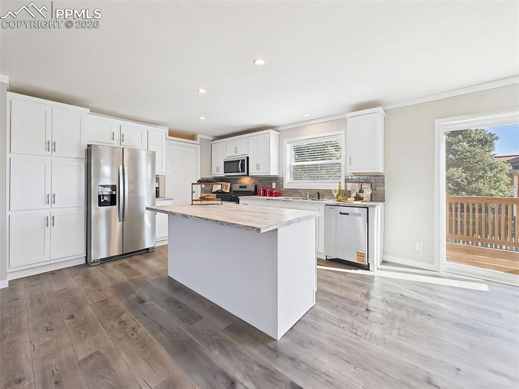 Image 21 of 50: Kitchen Island & Workspace – The expansive center island offers additional