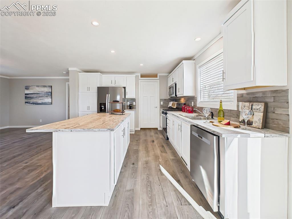 Image 22 of 50: Open Layout from Kitchen – From the island, enjoy views across the light-fi