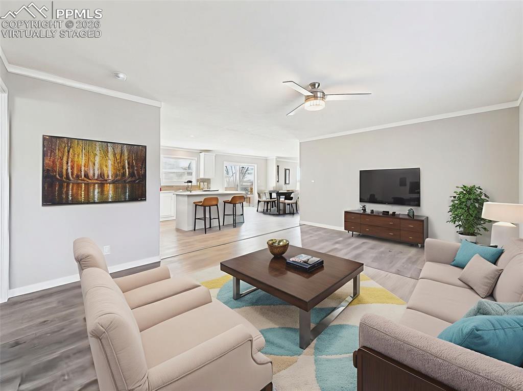 Image 30 of 50: Virtually Staged View to Kitchen – With barstools at the island and a cozy
