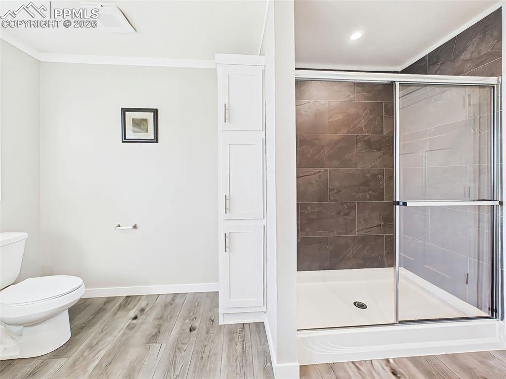 Image 34 of 50: Walk-In Shower & Storage – The primary bath includes a sleek, glass-enclose
