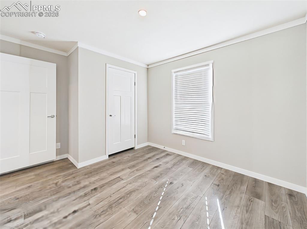 Image 36 of 50: Unstaged Secondary Bedroom – This bright and functional room offers clean f