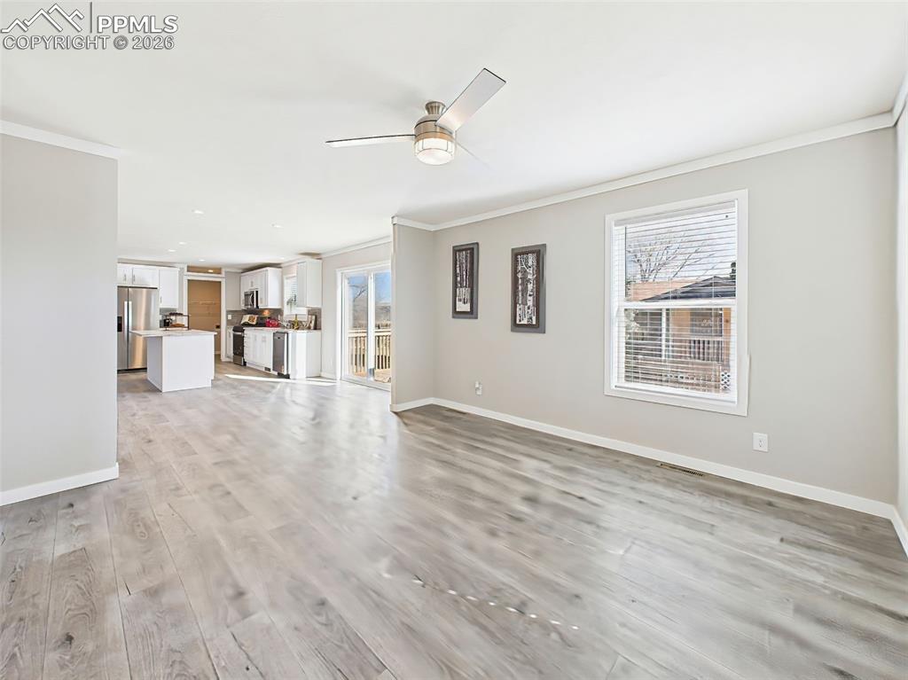 Image 6 of 50: Living Room & Kitchen View – A bright and expansive layout connects the liv