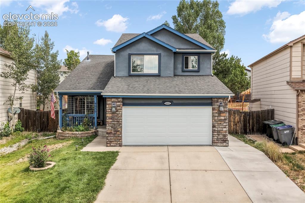 Caption: Front of 2 story home with covered front porch