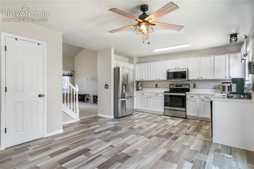 Image 12 of 50: Kitchen with new LVP floors, stainless steel appliances, pantry and abundan