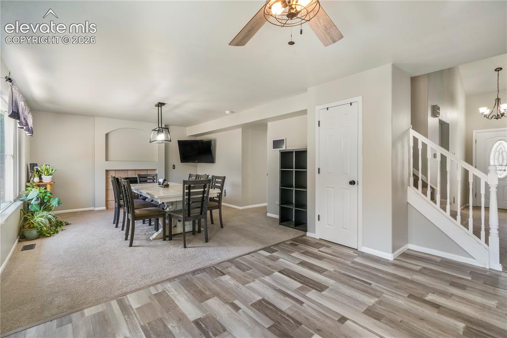 Image 13 of 50: Kitchen with new LVP floors looking into dining room/family room with acces