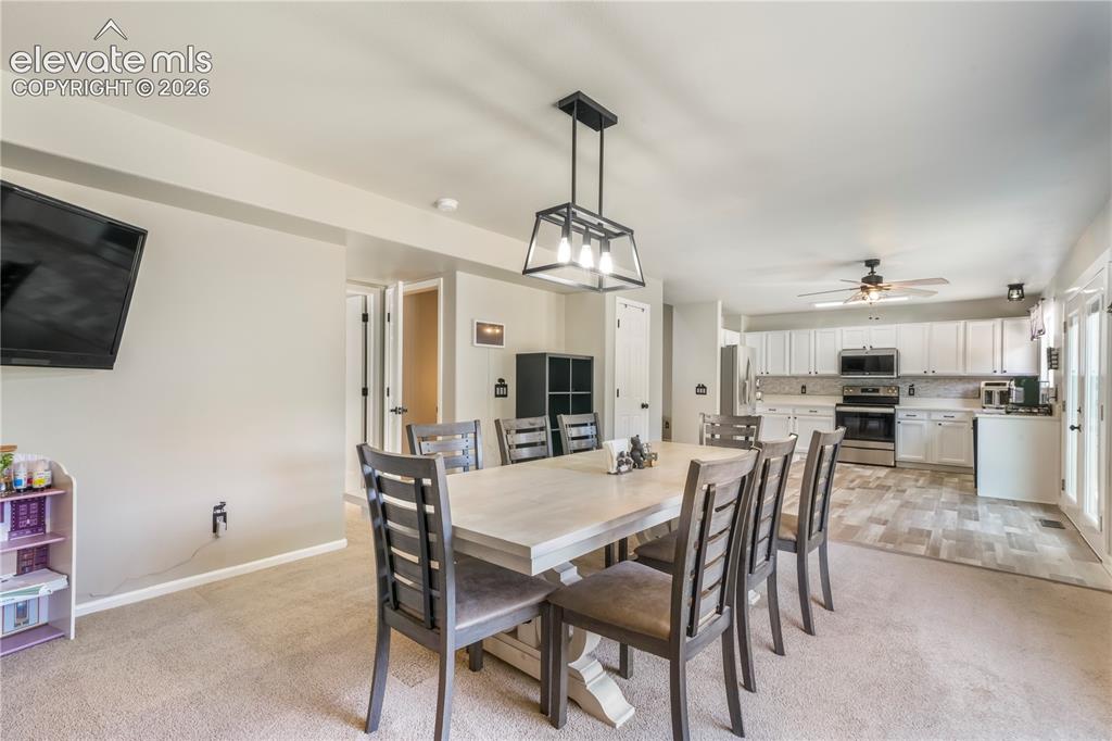 Image 15 of 50: Currently staged as dining area, also family room with gas fireplace