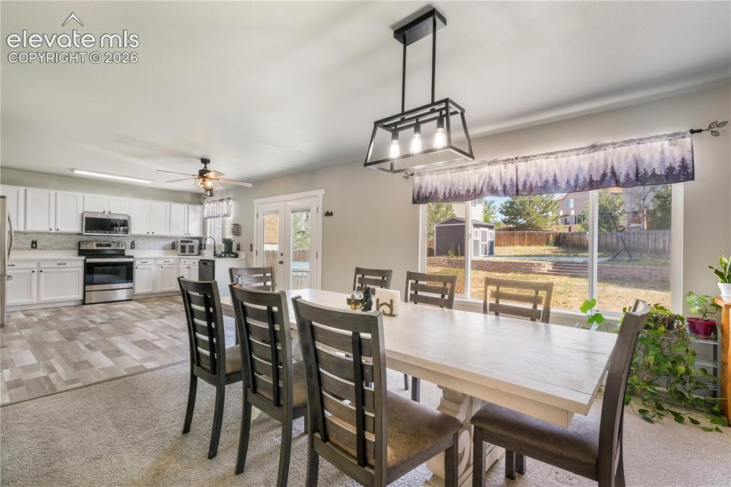 Image 16 of 50: Currently staged as dining area, also family room with gas fireplace