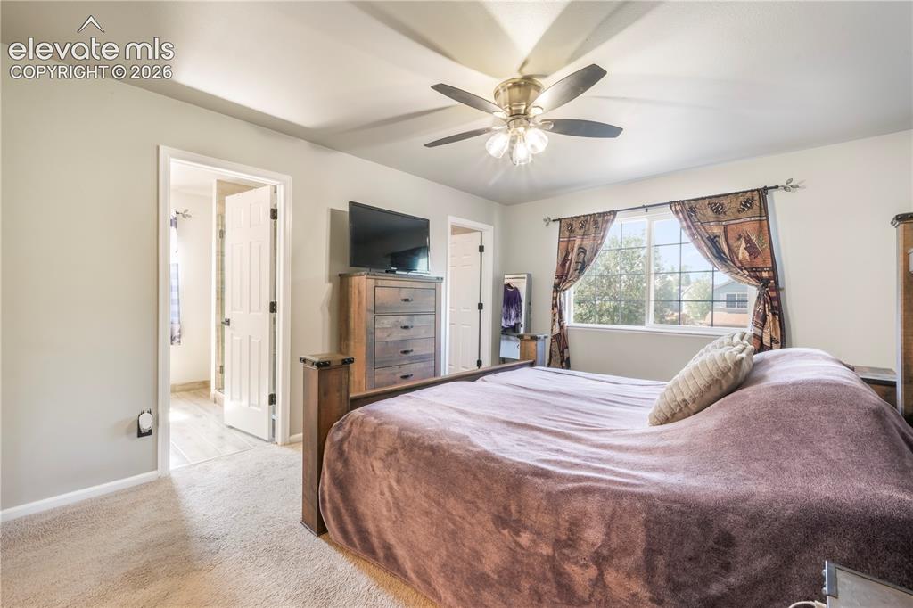 Image 25 of 50: Upstairs Primary bedroom with views of Pikes Peak, 2 closets and updated ba