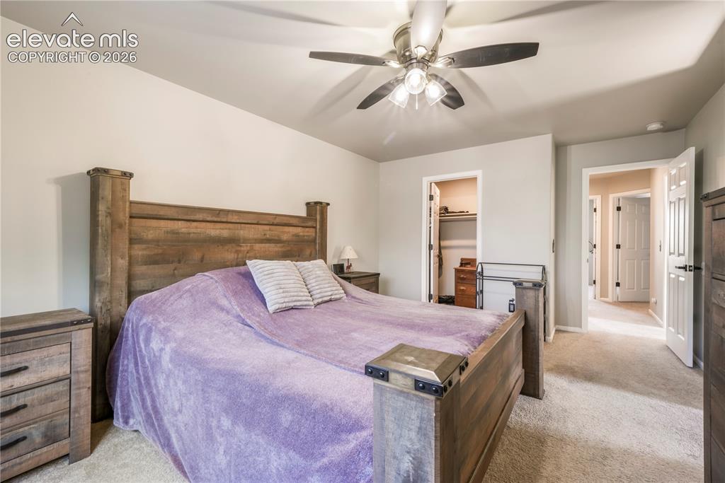 Image 26 of 50: Upstairs Primary bedroom with views of Pikes Peak, 2 closets and updated ba