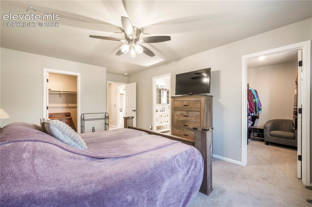 Image 27 of 50: Upstairs Primary bedroom with views of Pikes Peak, 2 closets and updated ba