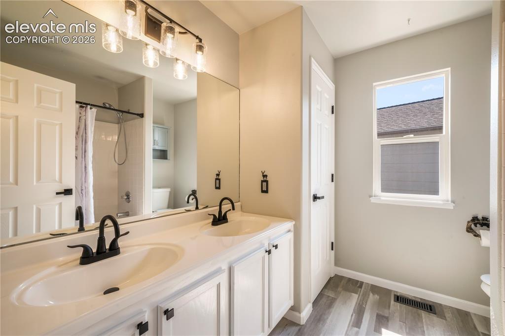 Image 34 of 50: Upstairs updated full bathroom with dual vanities