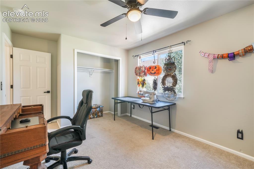 Image 36 of 50: Upstairs 5th bedroom currently staged as an office/craft room