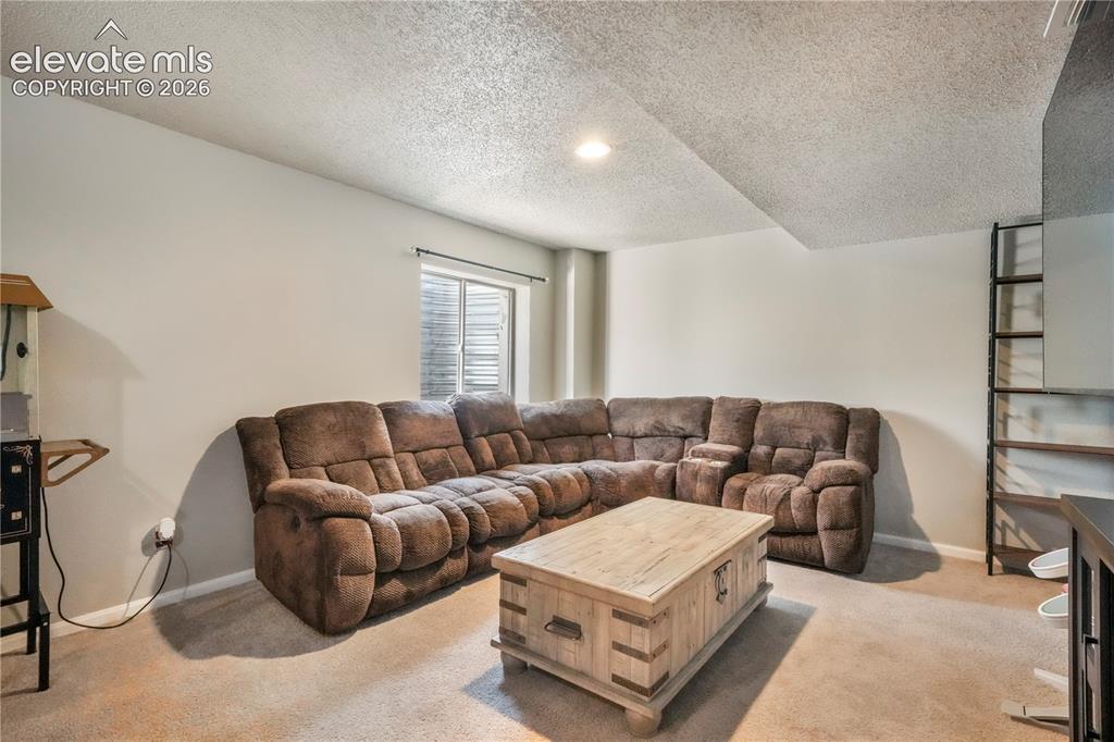 Image 37 of 50: Basement family room with bar area