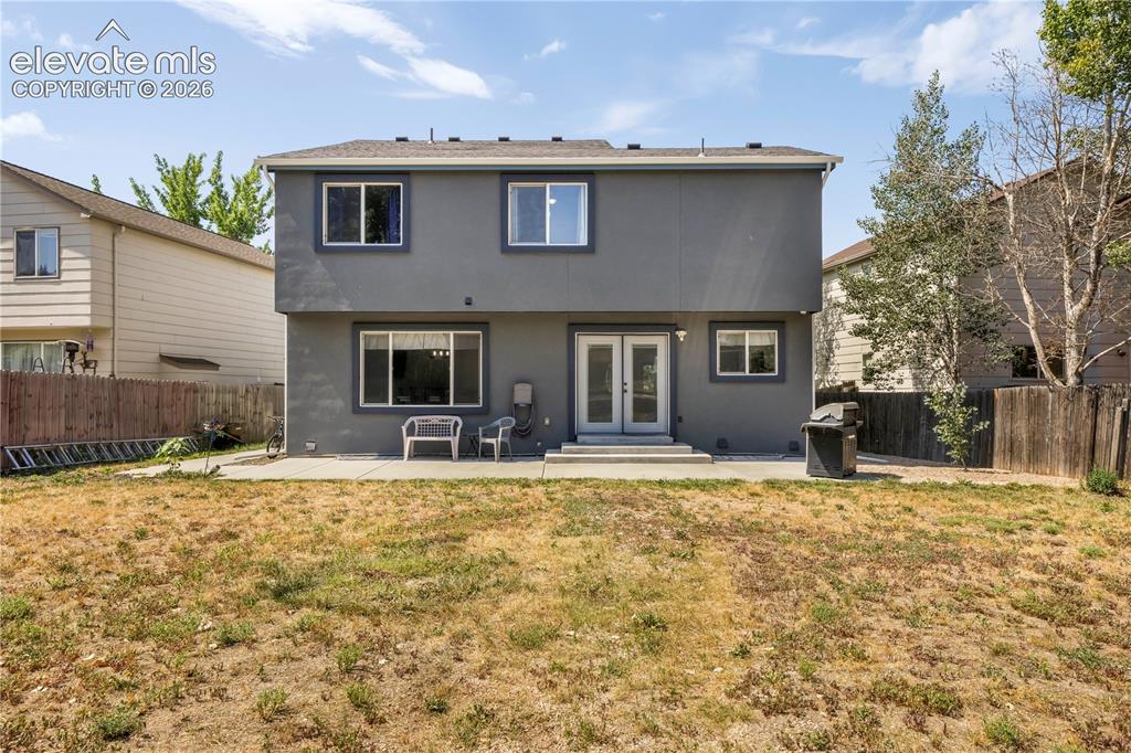 Image 45 of 50: Back of home with large backyard patio, multiple levels, basketball goal an