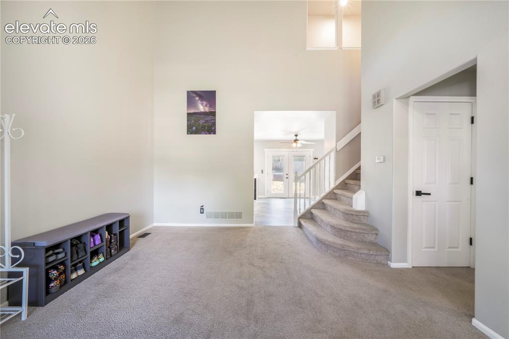 Image 7 of 50: Front formal living room, access to main 1/2 bath, laundry, garage access a
