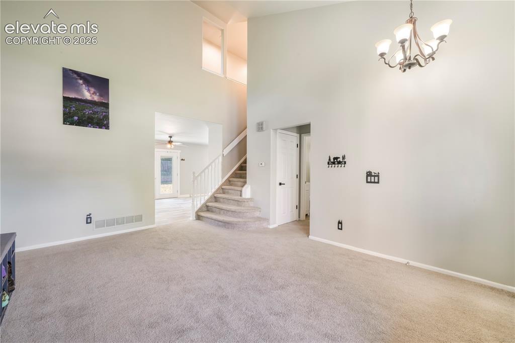 Image 8 of 50: Front formal living room, access to main 1/2 bath, laundry, garage access a