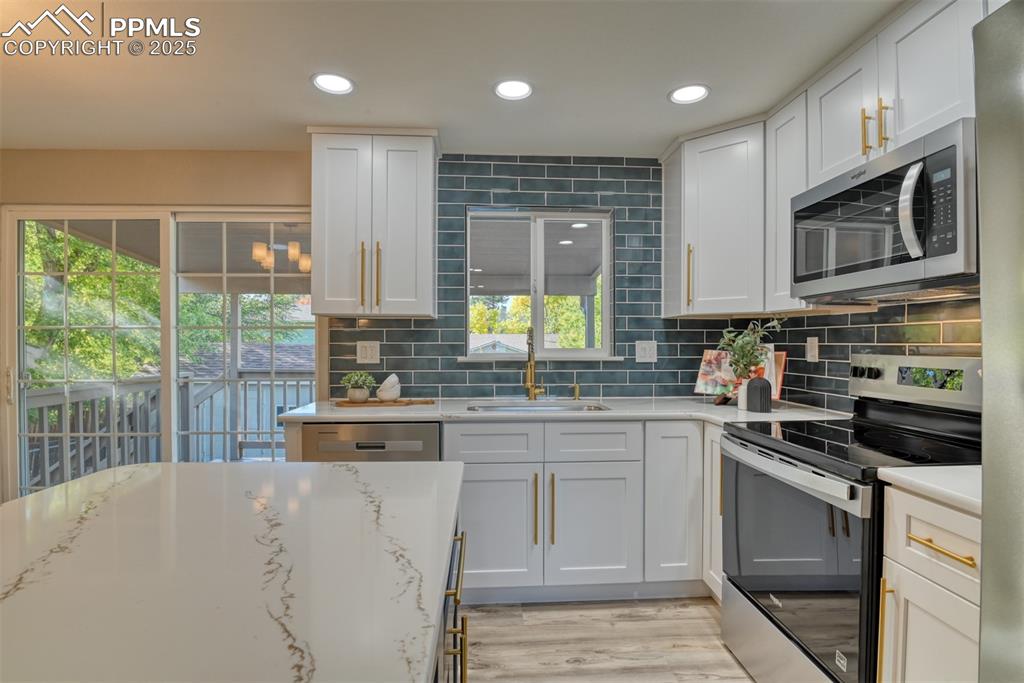 Image 12 of 48: Kitchen featuring appliances with stainless steel finishes, tasteful backsp