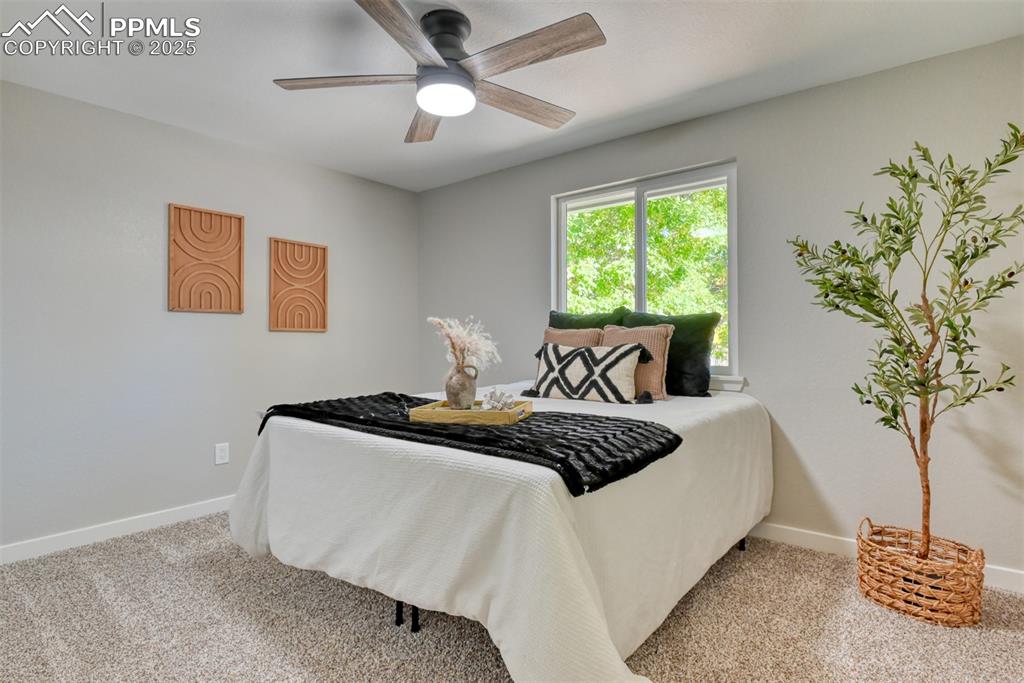 Image 18 of 48: Bedroom with carpet flooring and a ceiling fan