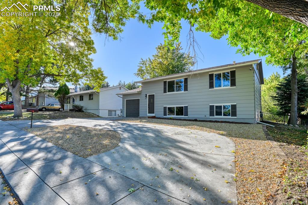 Image 2 of 48: View of front of house with concrete driveway