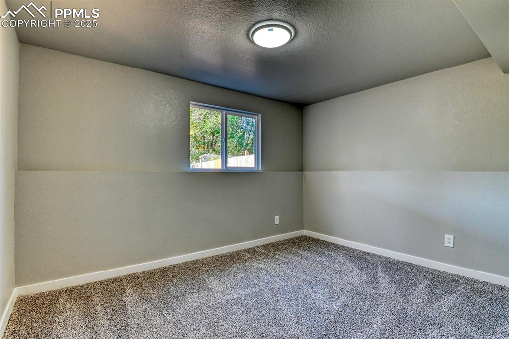Image 29 of 48: Unfurnished room featuring carpet flooring and a textured ceiling