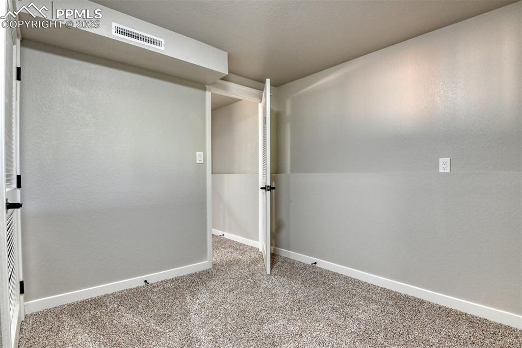 Image 40 of 48: Spare room featuring light carpet and baseboards