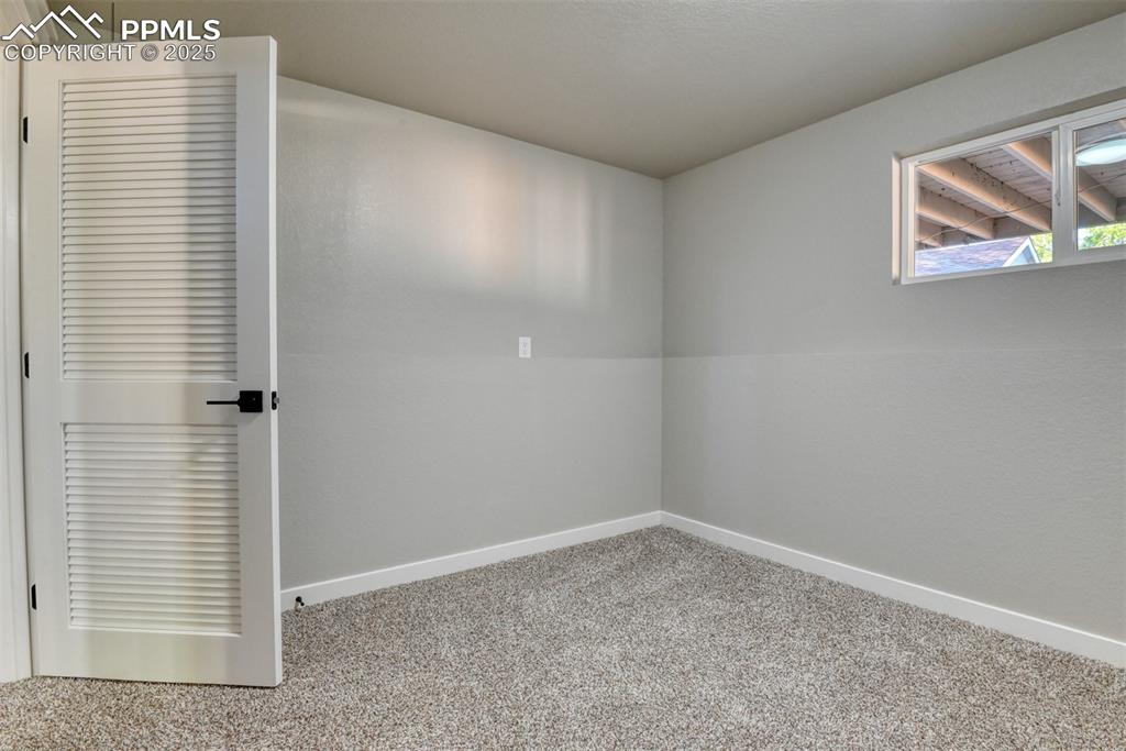 Image 41 of 48: Unfurnished room with baseboards and carpet