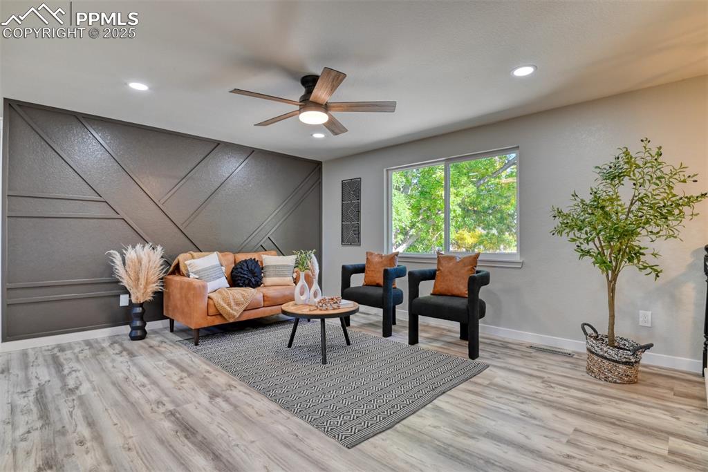 Image 5 of 48: Living area with ceiling fan, wood finished floors, recessed lighting, and 
