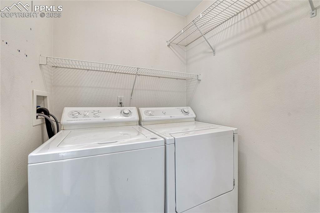 Image 24 of 47: Main level laundry off of kitchen area and washer/dryer are included!