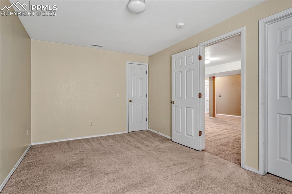 Image 39 of 47: Bedroom #3 with two closets, one is a walk-in closet