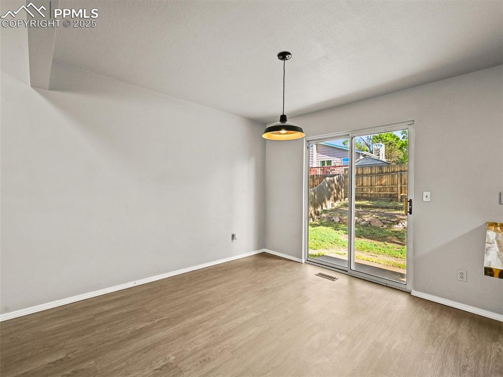Image 14 of 47: Unfurnished dining area featuring wood finished floors and baseboards