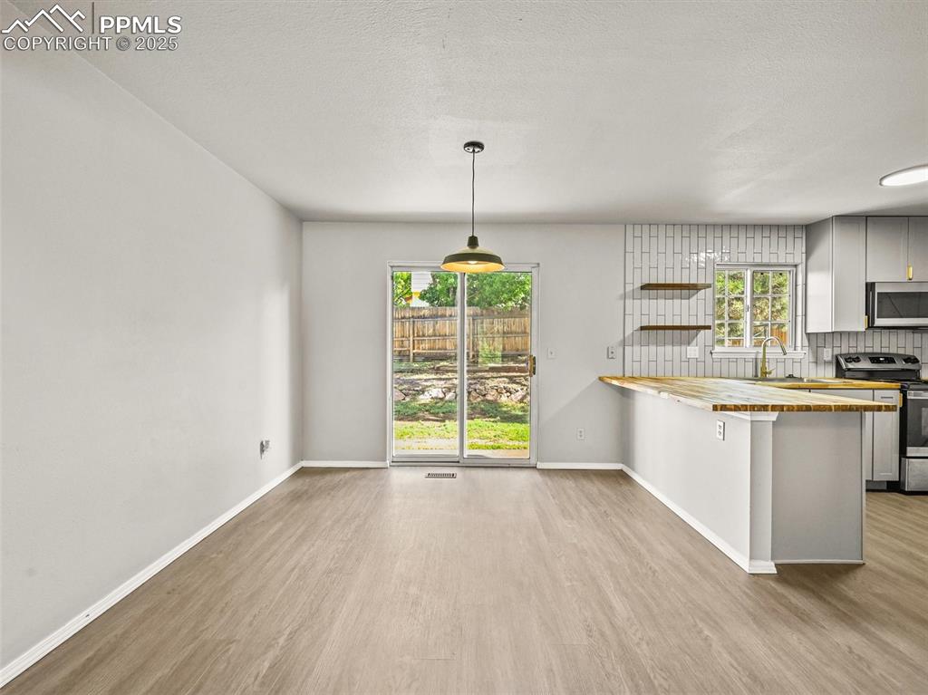 Image 15 of 47: Kitchen featuring appliances with stainless steel finishes, wooden counters