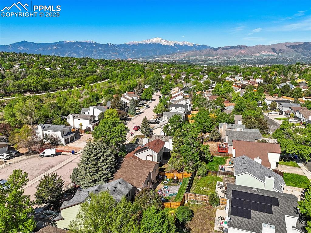 Image 2 of 47: Aerial view of residential area with a mountain backdrop