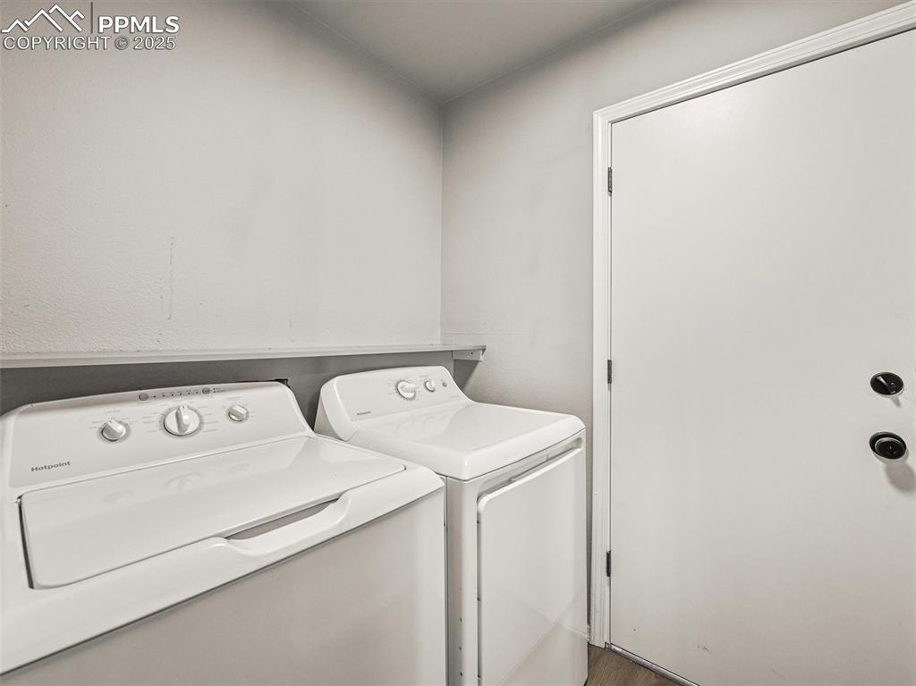 Image 22 of 47: Laundry room featuring separate washer and dryer and wood finished floors