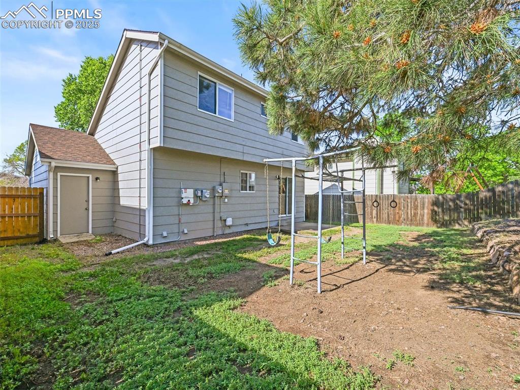 Image 25 of 47: Rear view of property featuring a fenced backyard