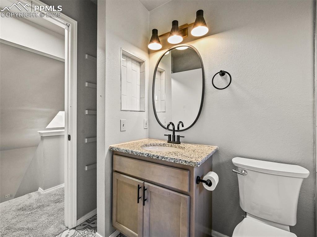 Image 31 of 47: Half bath with vanity and toilet