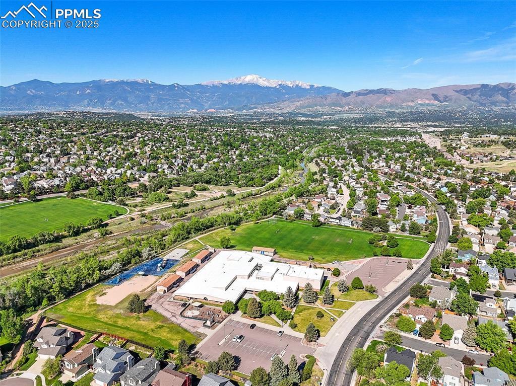 Image 37 of 47: Aerial view of property and surrounding area featuring a mountainous backgr