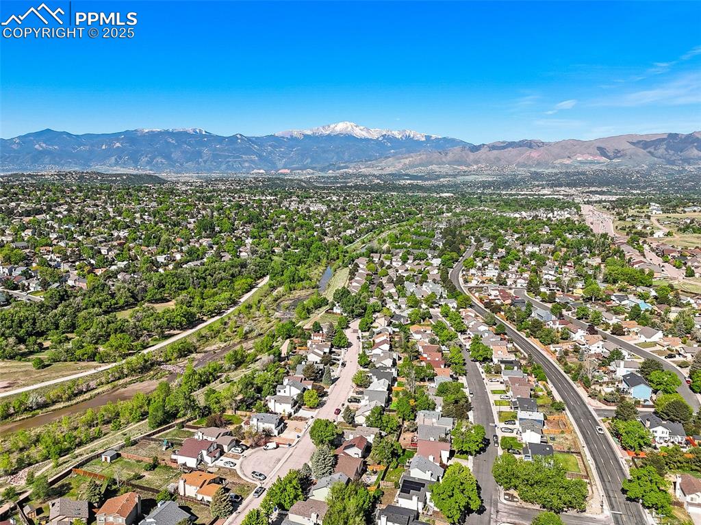 Image 41 of 47: Aerial view of residential area with a mountainous background