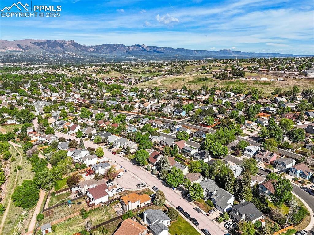 Image 43 of 47: View of property location with mountains and nearby suburban area