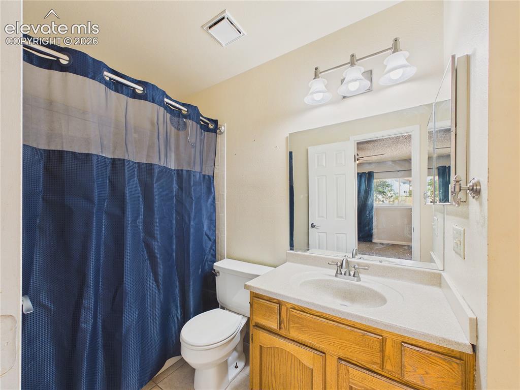 Image 23 of 46: Convenient bathroom featuring a large vanity, ample counter space, and a tu