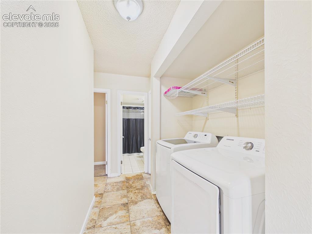 Image 26 of 46: Convenient laundry area with included washer and dryer plus abundant built-