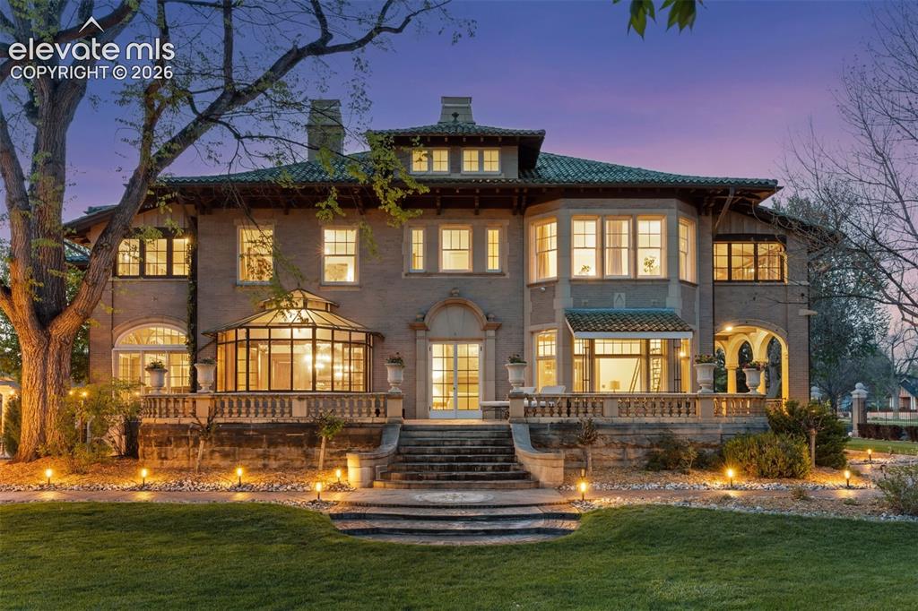 Image 2 of 50: Grand southern patio. A spacious open porch overlooking the lawn’s fountai