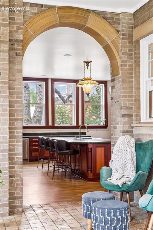 Image 21 of 50: Original stone arch sunroom off of kitchen