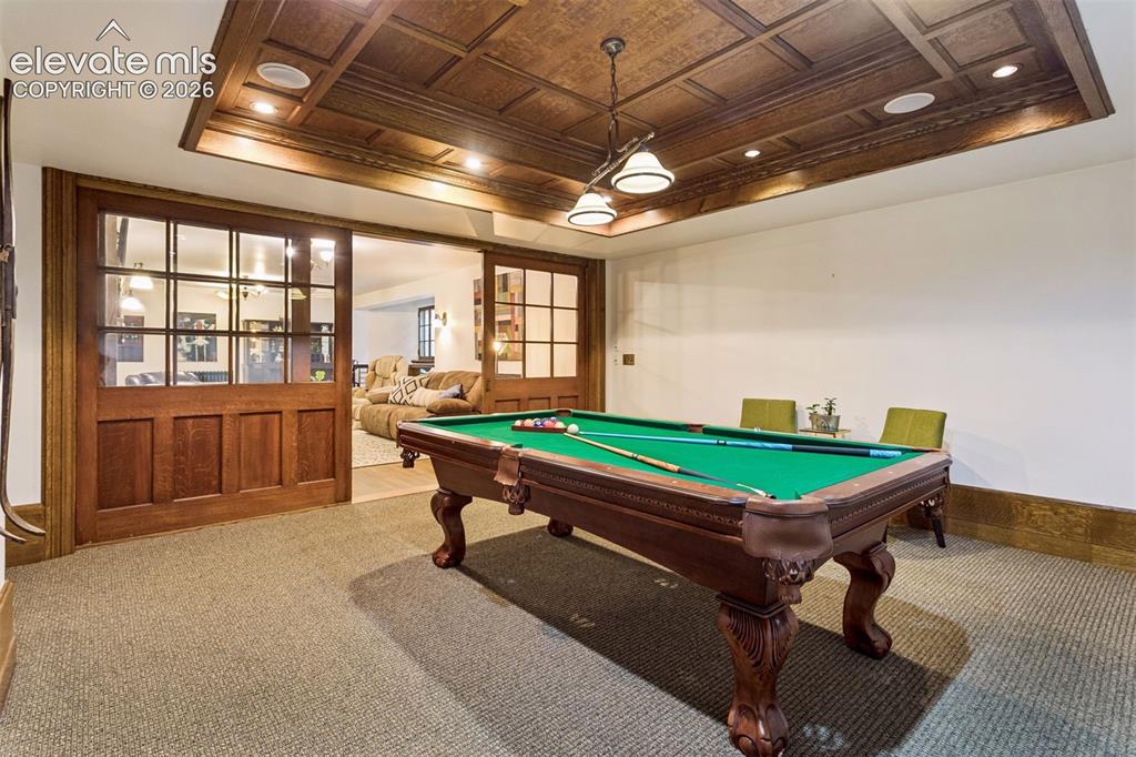 Image 24 of 50: Billiards room with oak paneling and original pocket doors