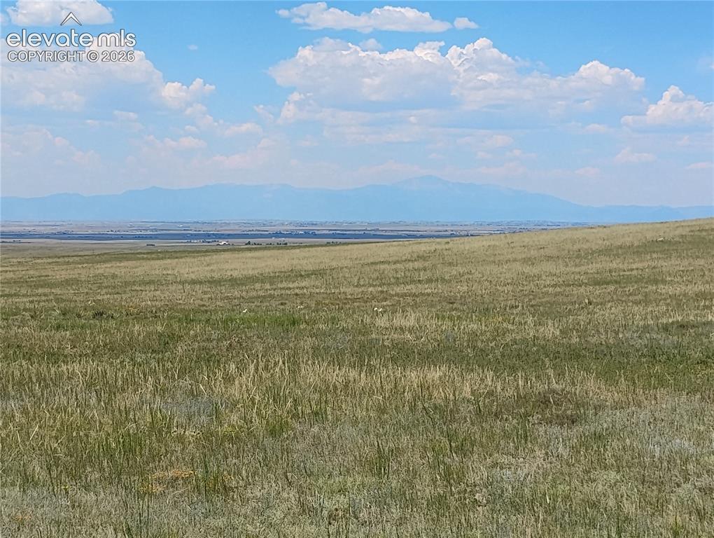 Image 1 of 15: Expansive open terrain featuring natural grasses, mountain and sunset views