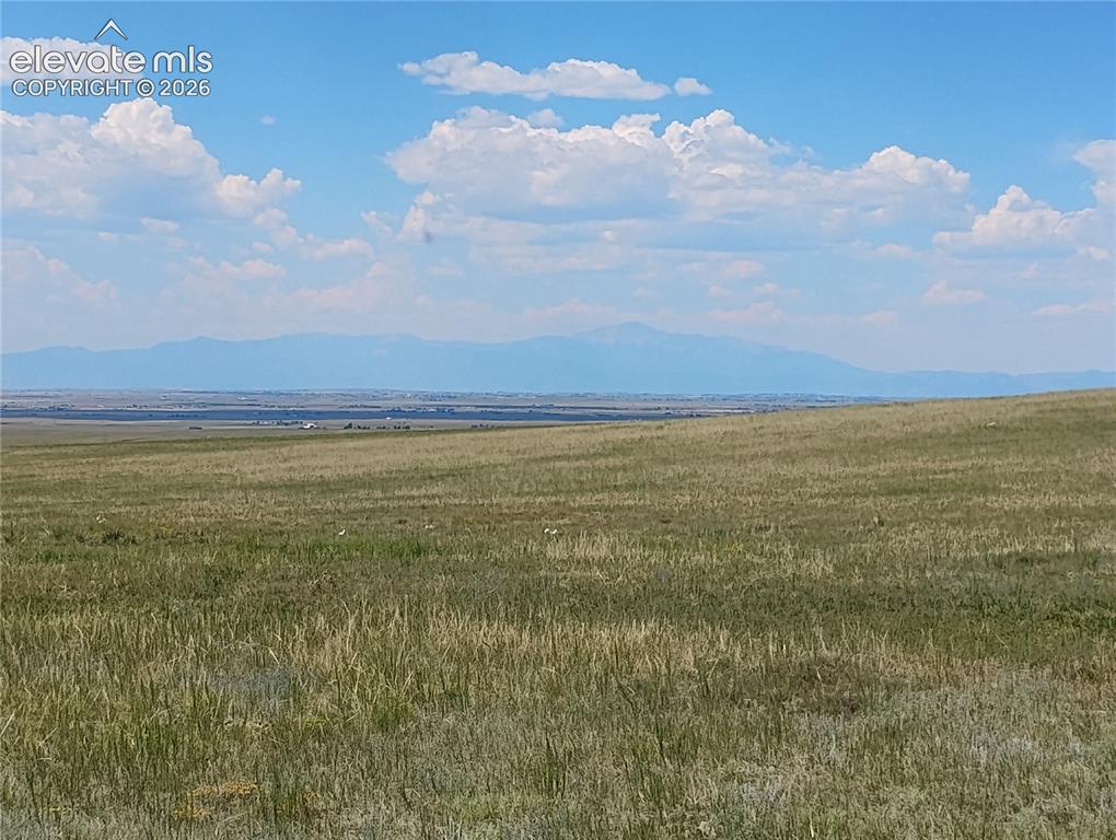 Image 6 of 15: Expansive open land featuring natural grasses and distant mountain ranges u